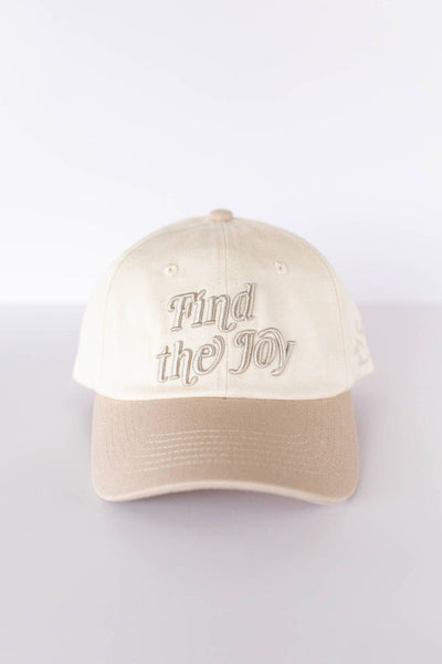Beige cap with 'Find the Joy' text on a white background
