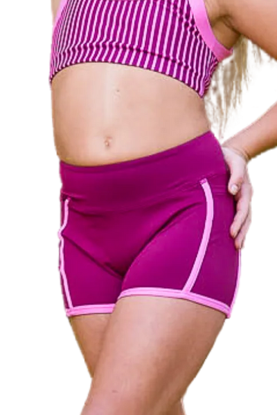 Woman wearing a pink athletic outfit on a white background