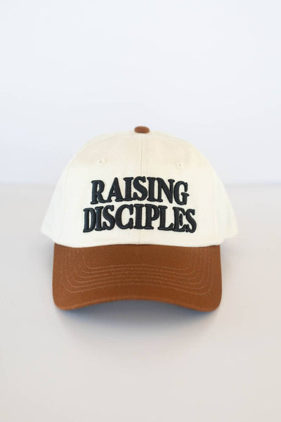 Cap with 'RAISING DISCIPLES' text on a white background