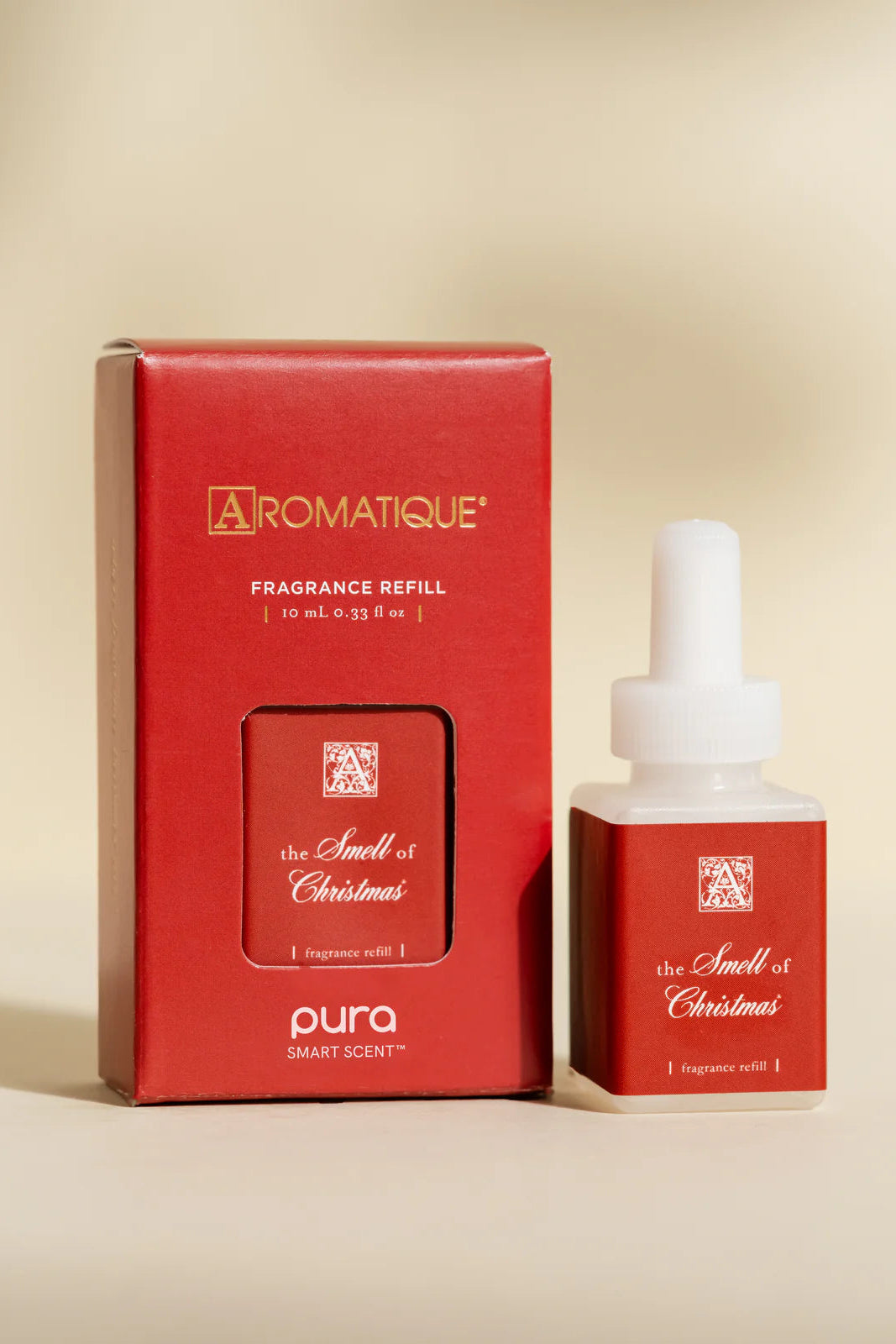 Red Aromatique fragrance refill packaging with dropper bottle on a beige background